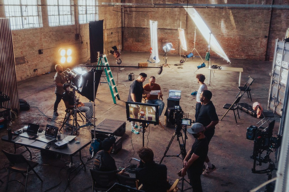 image of a film crew in a large warehouse