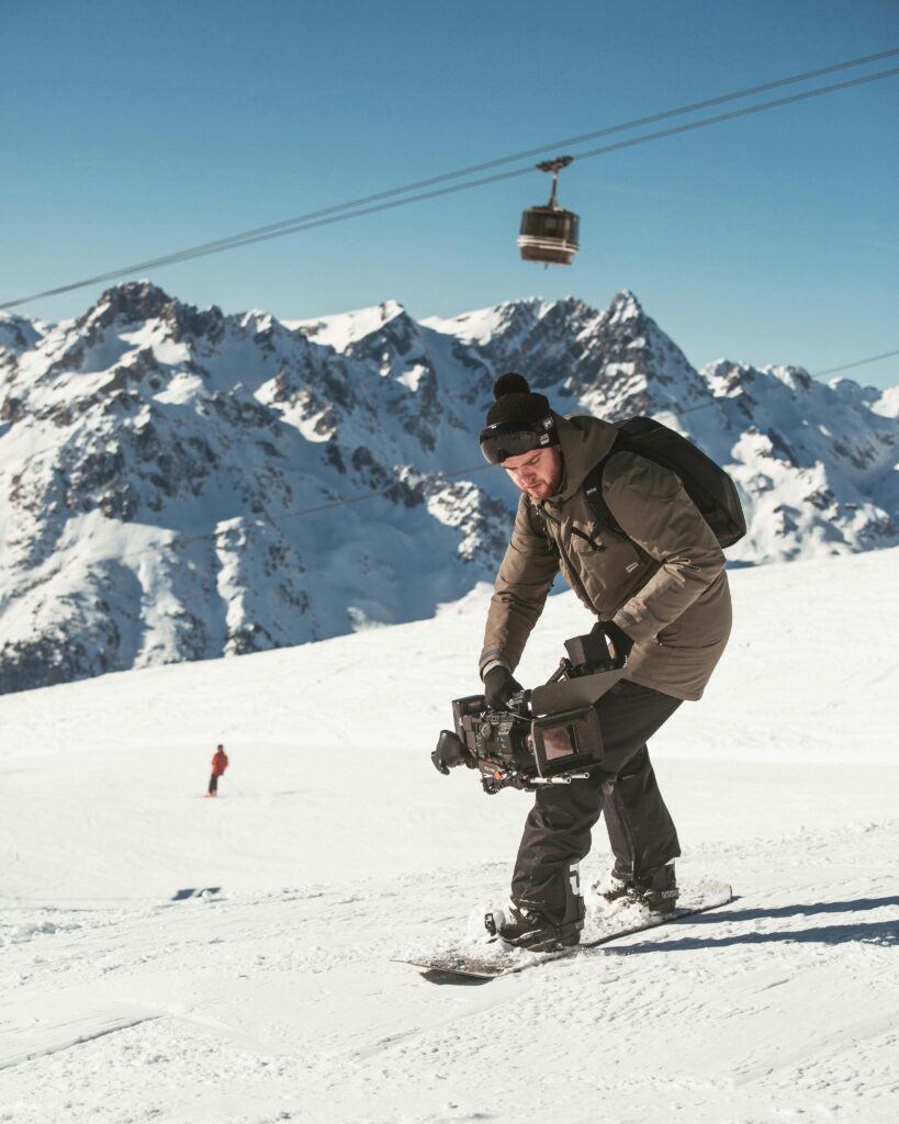 image of a cameraman filming on a ski slope