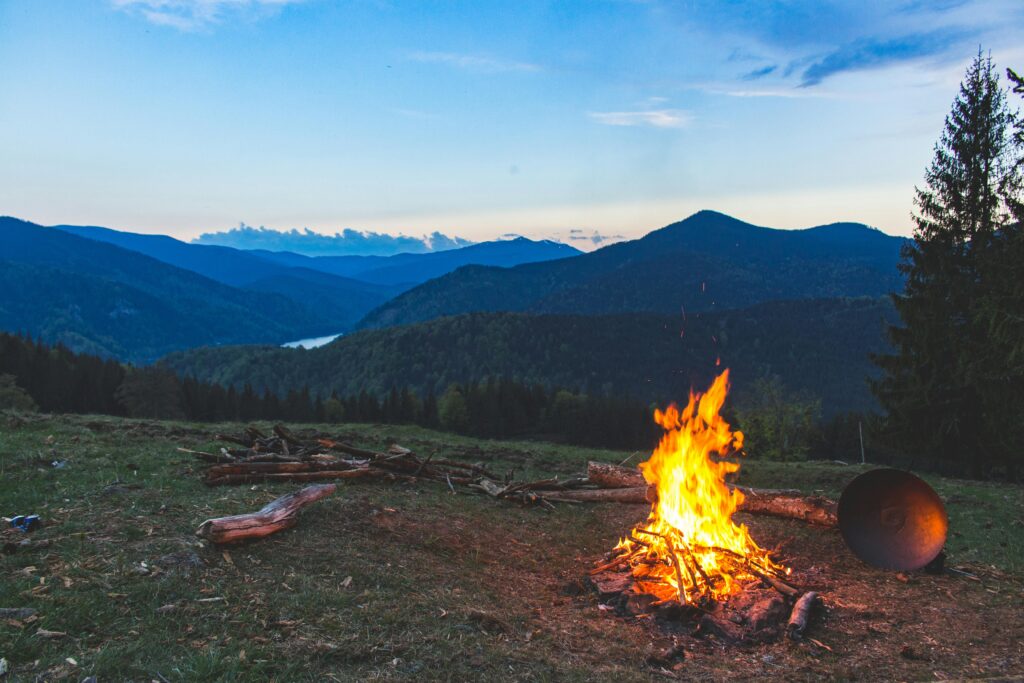 image showing a campfire atop a large hill