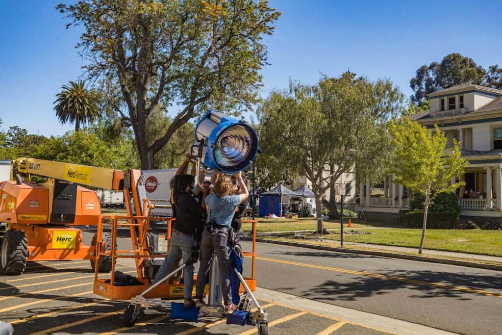 image of crew setting up a spotlight on the roadside