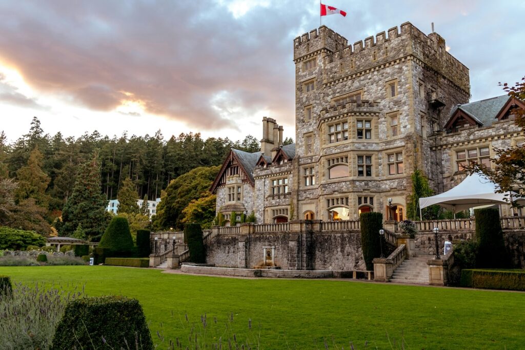 garden and exterior of stone castle with Canadian flag 