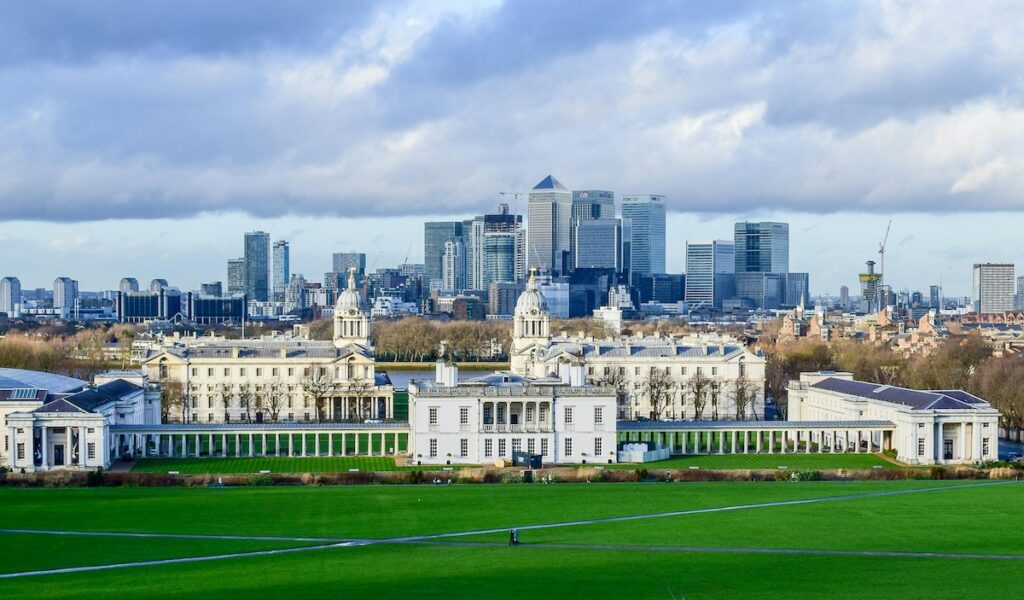 drone shot of The Old Royal Naval College with Canary Wharf in the background 