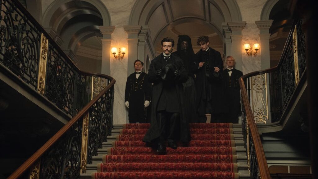 Film still from House of Guiness showing characters walking down a large staircase