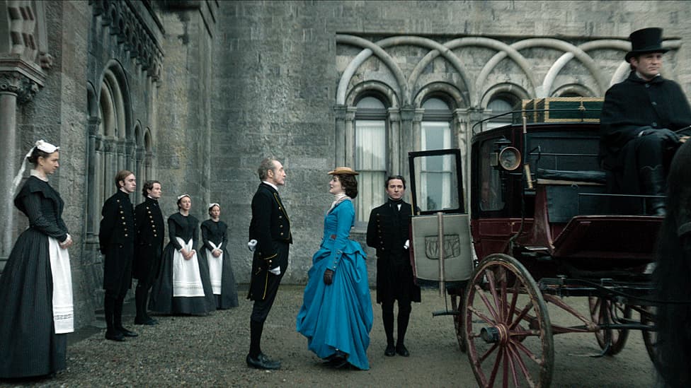 image of house of guiness characters standing in front of a stately home