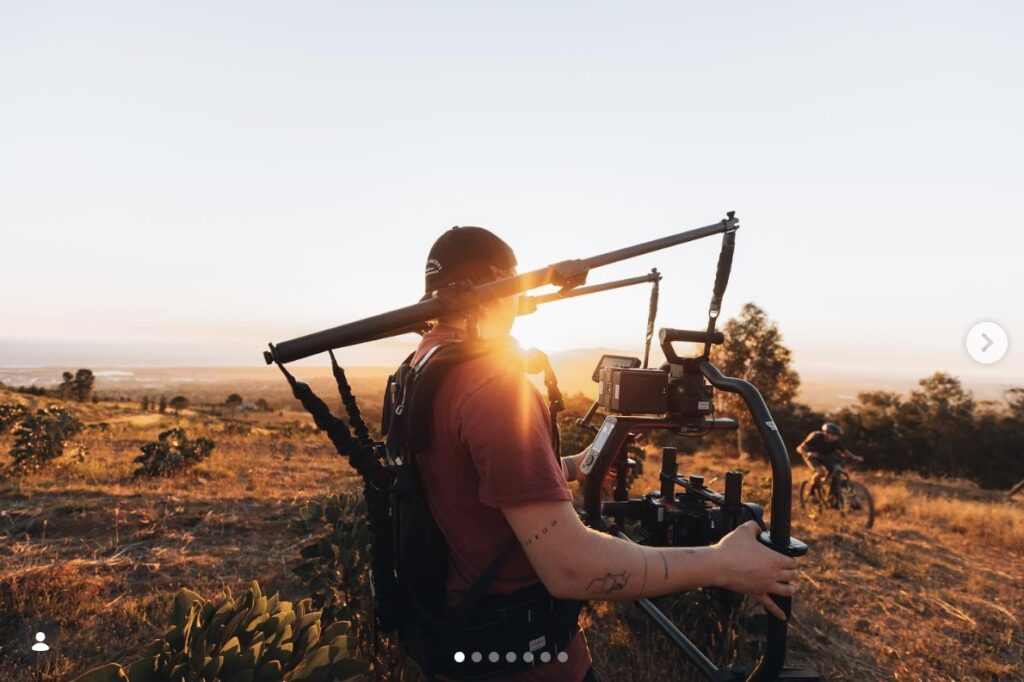 image showing an Instagram post of a man using film equipment in a field FOMO House 